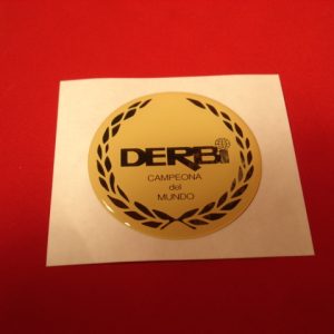 ADHESIVO DERBI CRUDO EN RESINA DE 49 MM DIAMETRO